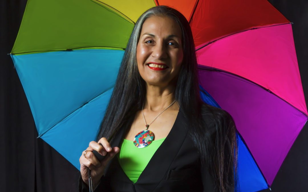 Montaha Hidefi holding a colorful umbrella
