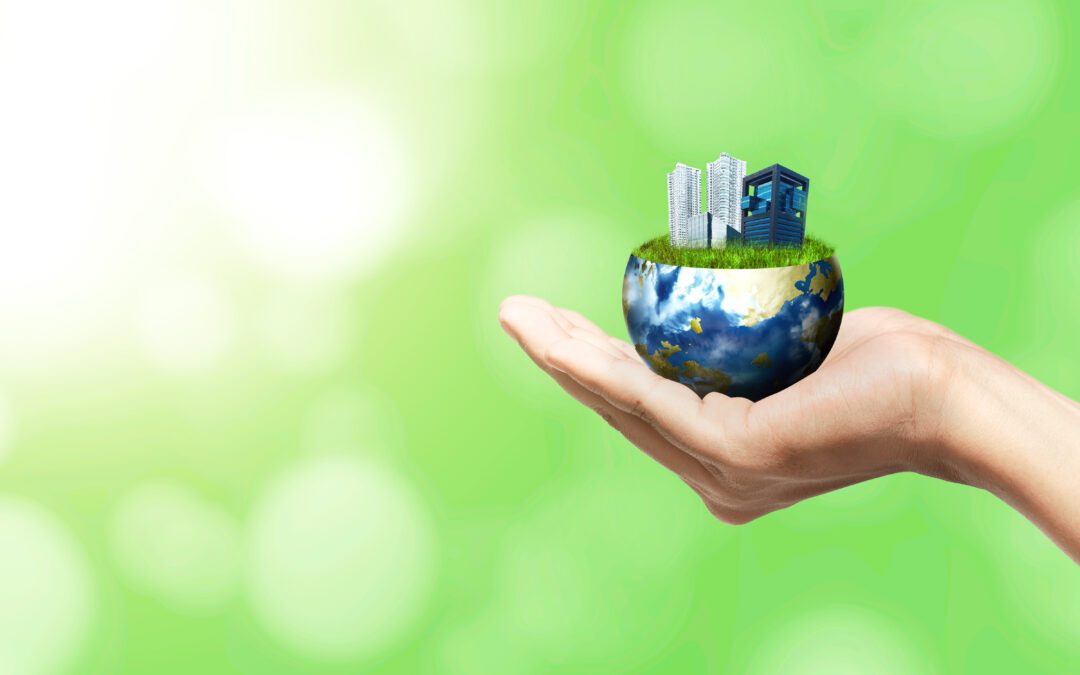 Human hand holding earth with buildings and apartments